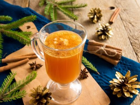 Hot buttered room glass with festive cones and spruce