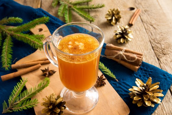 Hot buttered room glass with festive cones and spruce