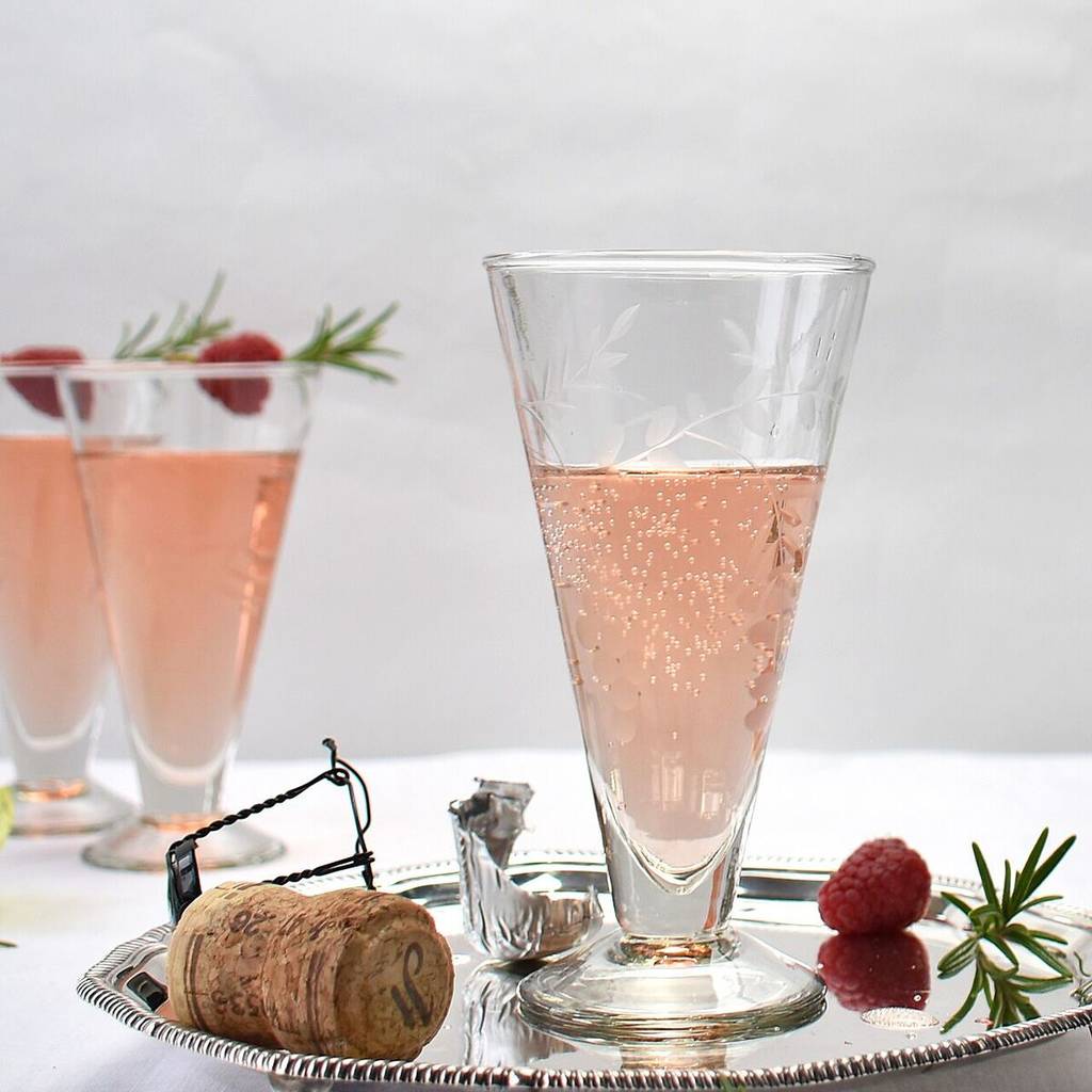 vinatage etched prsecco glasses filled with bubbling pink prosecco sold on not on the hogh street