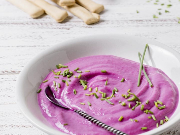 pastel pink colored beetroot dip in a white serving bowl