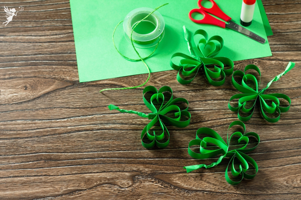 papaper shamrock crafts with scossors and green construction paper used to make st patricks day crafts