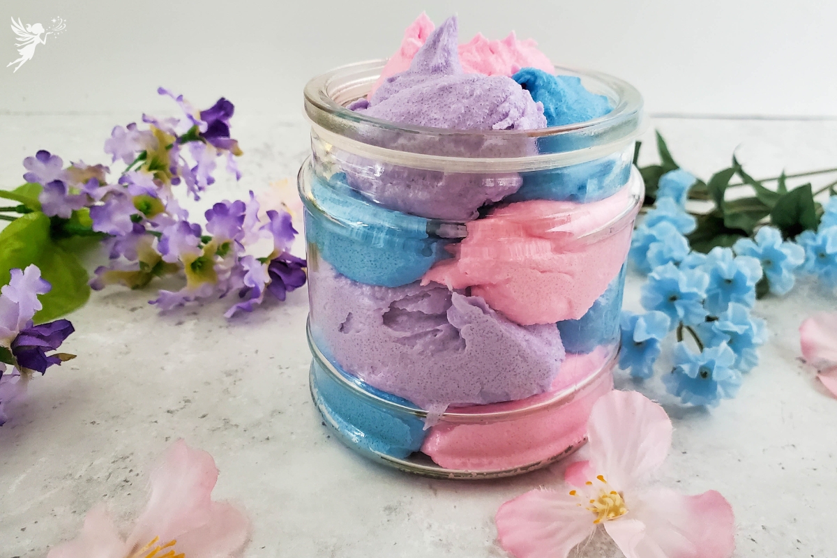 jar of pastel pink blue and purple home made body scrub in a jar