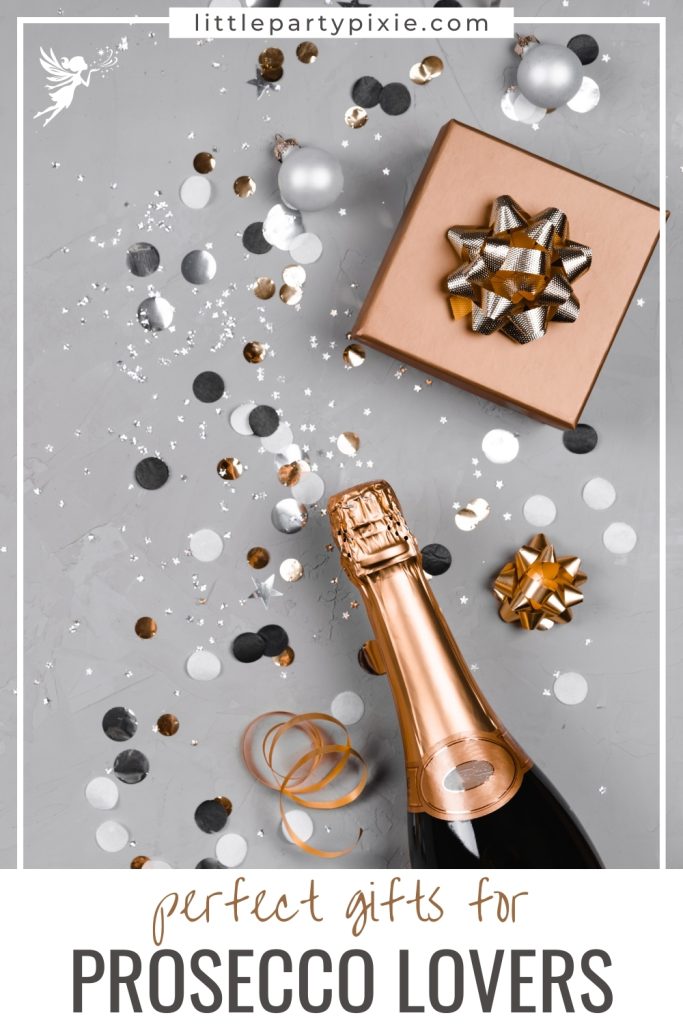 Gold prosecco bottle, wrapped gift, confetti, and festive decorations displayed