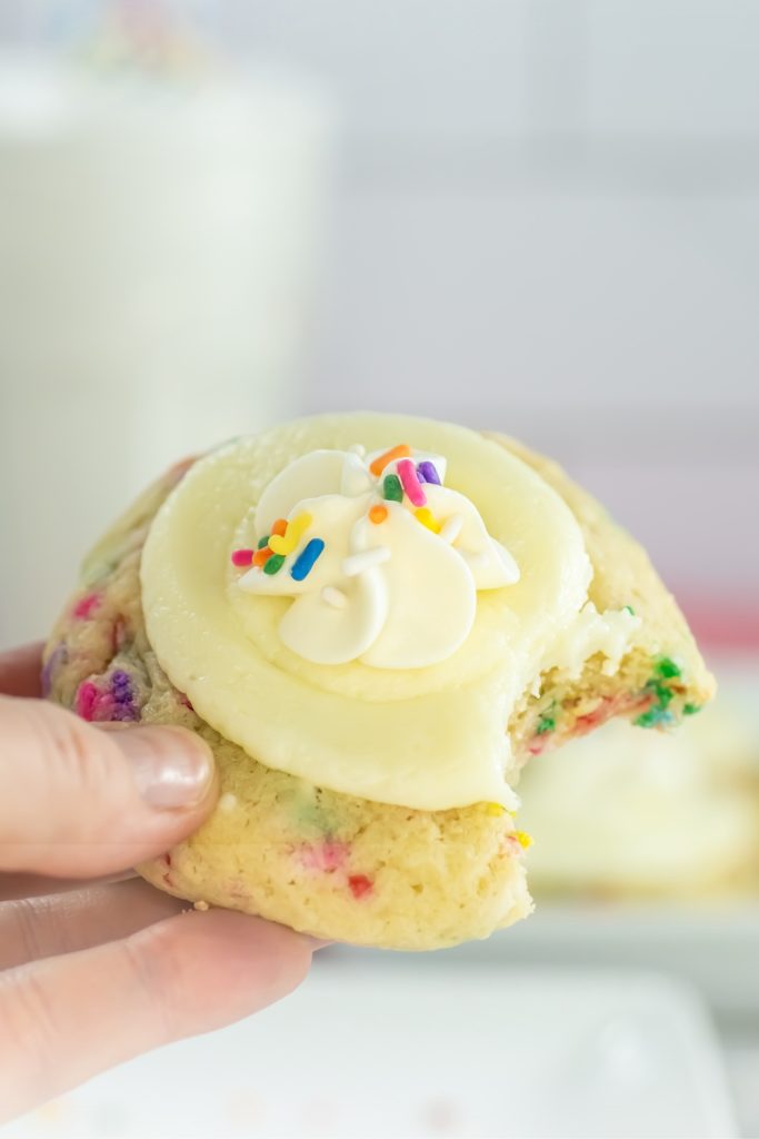 close up of a hand holding a funfetti milkshake cookie