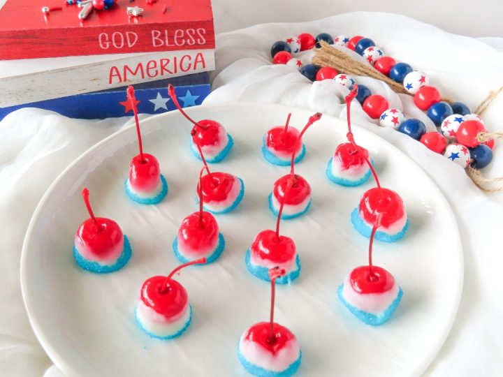 Red, white, and blue patriotic cherry bombs on plate, with festive Fourth of July decorations.