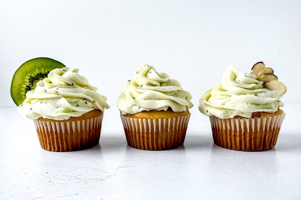 Process image for making Almond Kiwi Cupcakes - garnish cupcakes with sliced kiwi and almonds