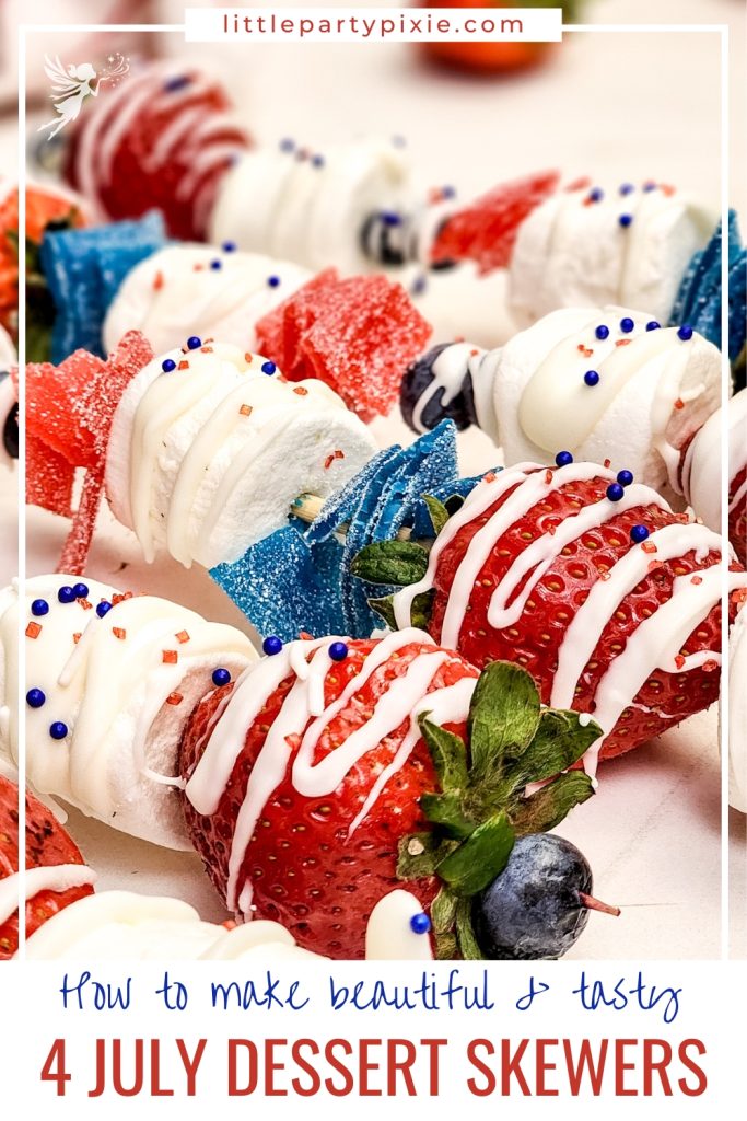Red, white, and blue dessert skewers with strawberries, marshmallows, candy strips, blueberries, white chocolate drizzle and patriotic sprinkles.