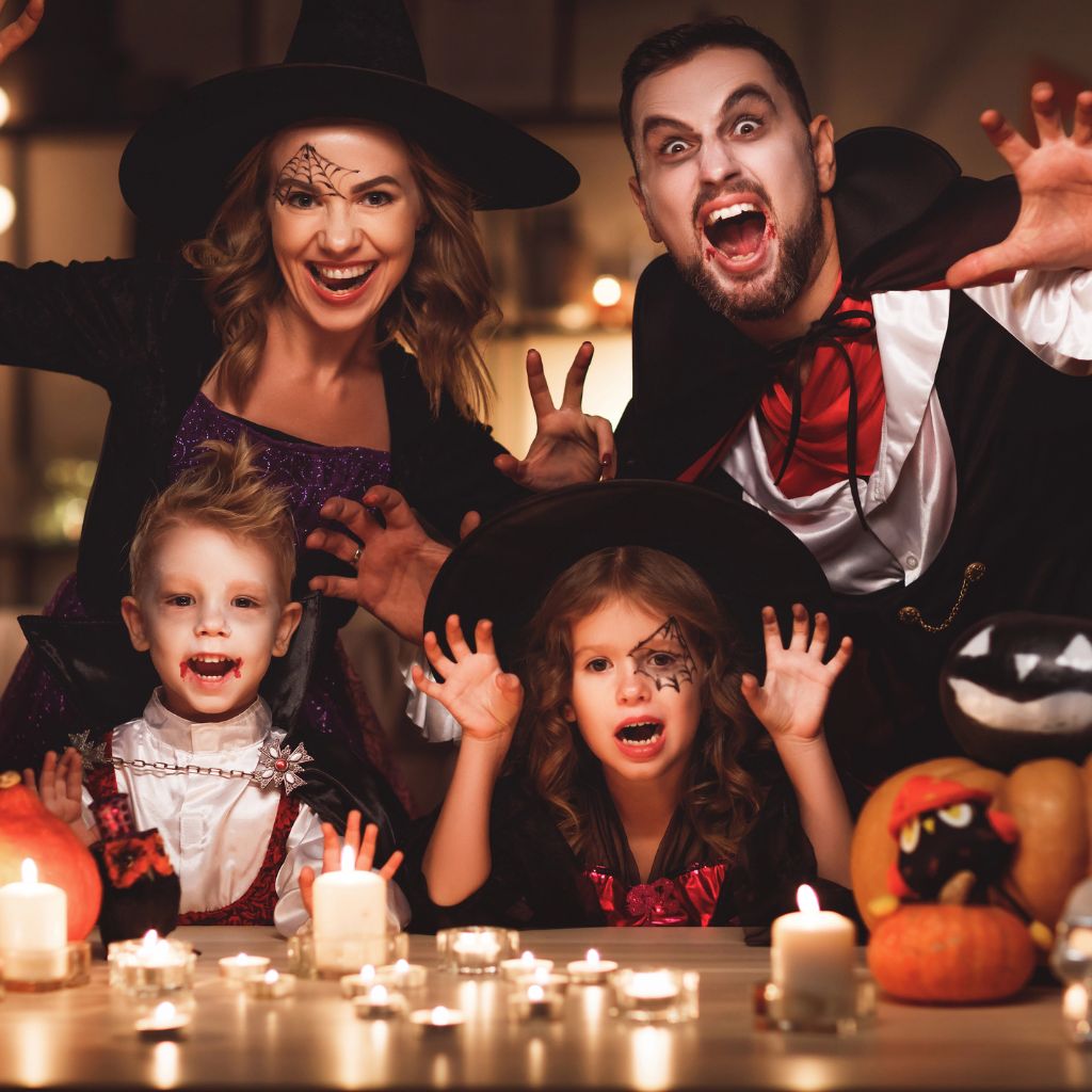 fmaily with mom dad and two children dressed in spooky halloween costumes for a family