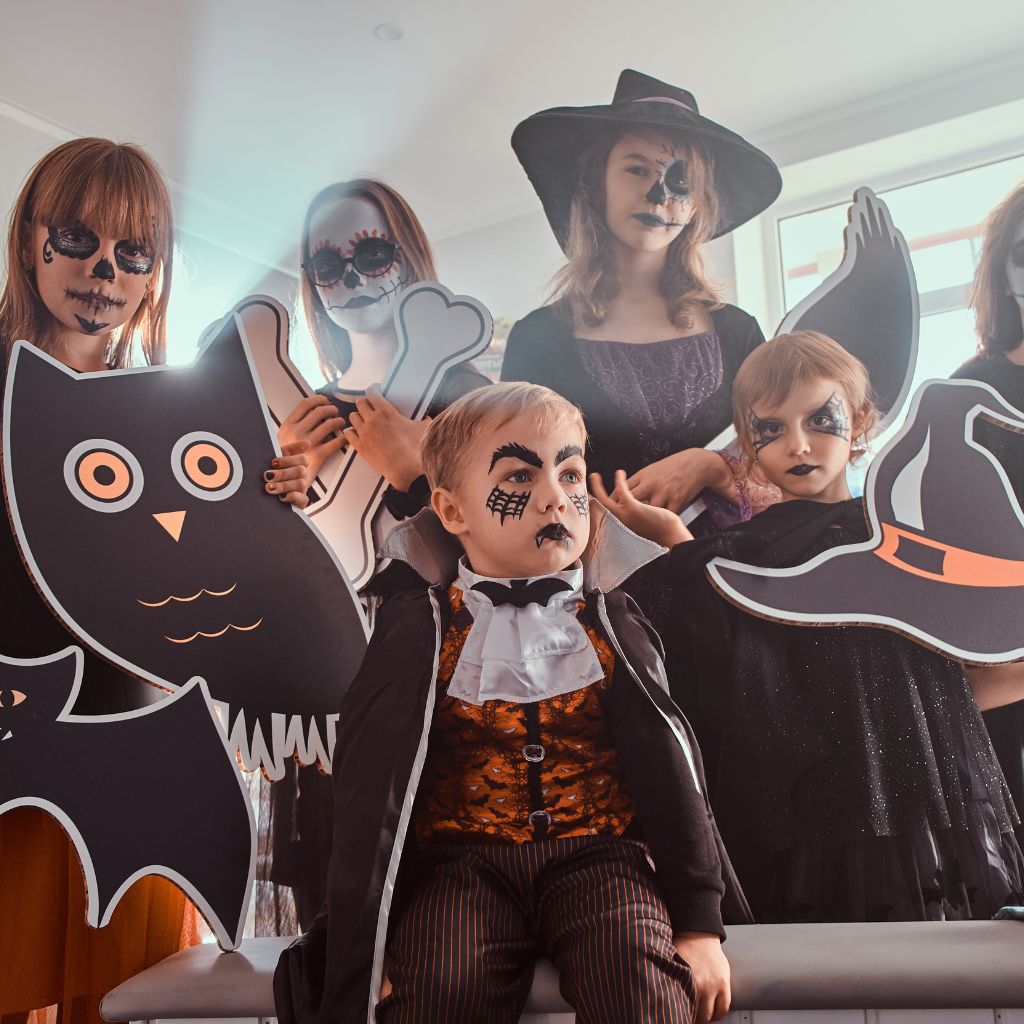 group of kids wearing sppoky dracula and witches costumes