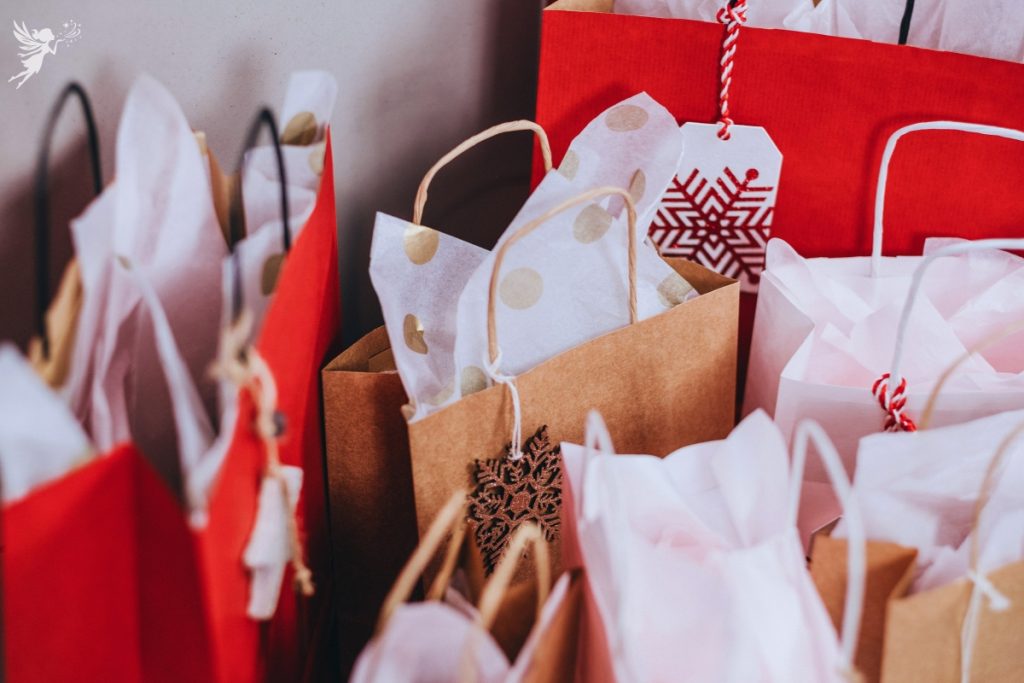 christmas gift bags lined up ready with gift tags