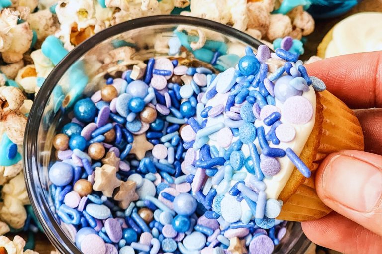 Cupcake dipped in blue or ocean-themed sprinkles