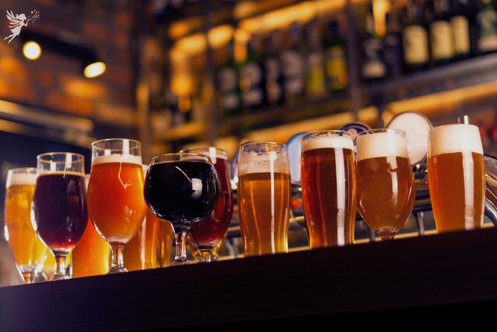 selection of different colored beers on a bar counter