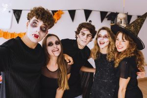 group of teenagers wearing Halloween costumes