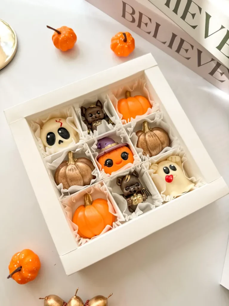 box of premium gourmet halloween homemade belgium callebaut chocolates in the shape of little skulls, ghost, pumpkins and symbolim halloween themed in a presentation gift box on etsy