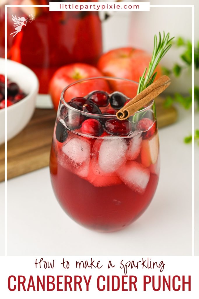 A vibrant glass of Sparkling Cranberry Apple Cider Punch with ice, cranberries, a cinnamon stick, and a fresh rosemary sprig, ready to enjoy.