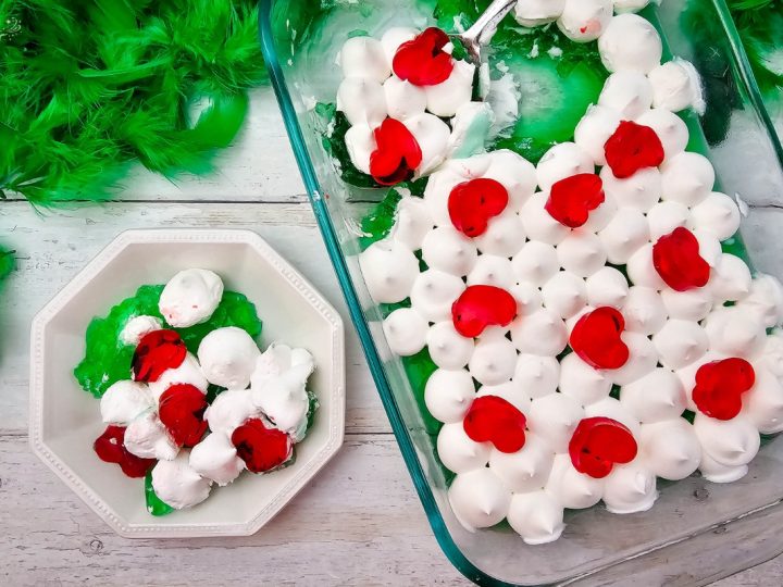 Served Grinch Jello dessert: A bowl and a baking dish filled with green jello, white topping, and red jello hearts.