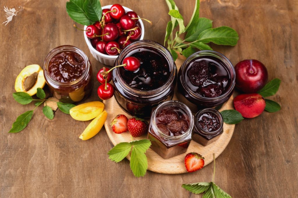 assortment of jams and preserves in jars on wooden table