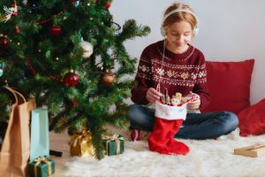 teen girl opening a christmas stocking