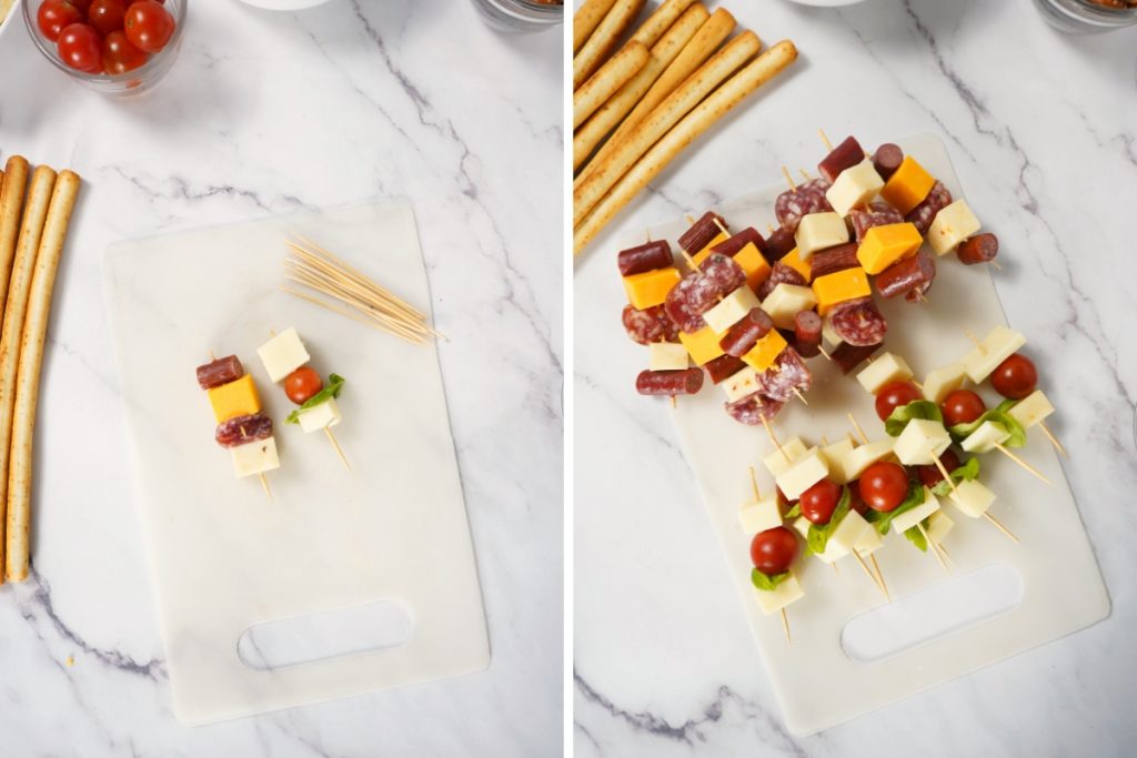 Process image for making individual charcuterie cup - assembled into skewers the meats, cheeses, cherry tomatoes, basil and grapes