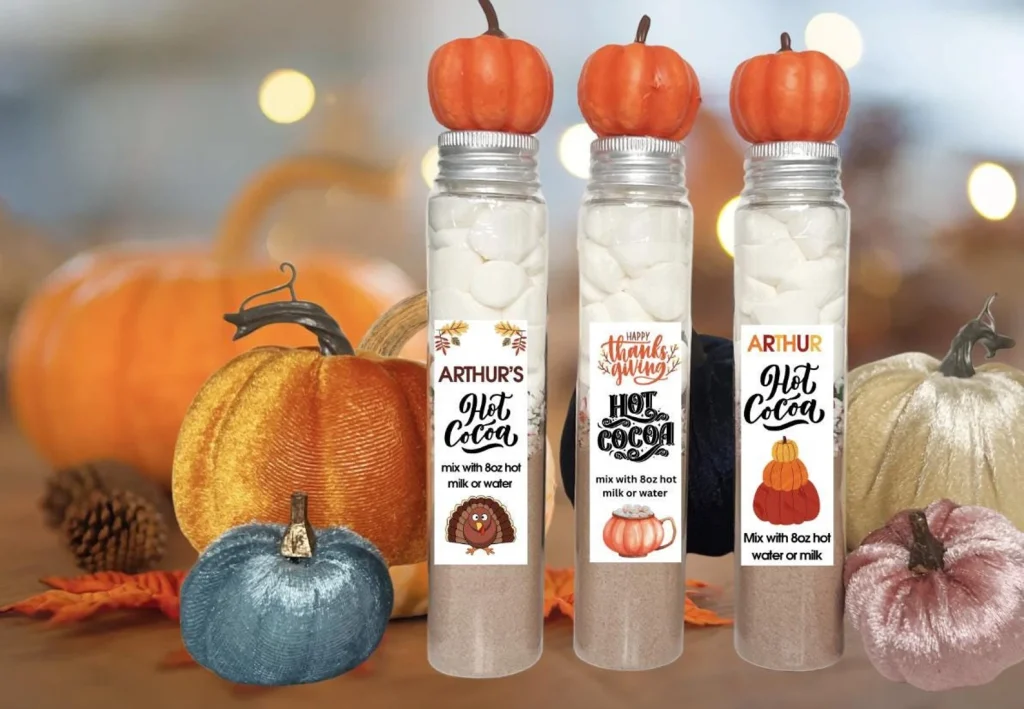 skinny jars with pumpkins on top filled with cocoa and perosanlized thanksgiving labels etsy
