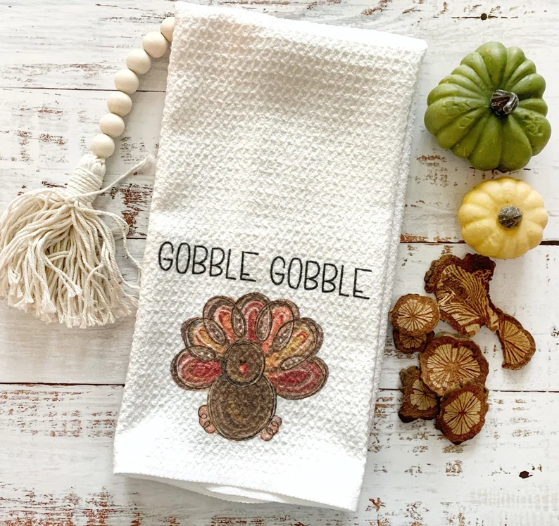 close up of an off white tea towel with emborided turkey gobble gobble etsy