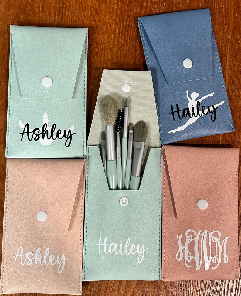 a colection of pastel colored makeup brush puches for travel with personalized names printed gift on etsy