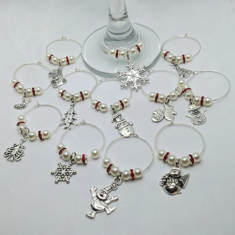 cute wine charm rings with schristmas motifs on white background