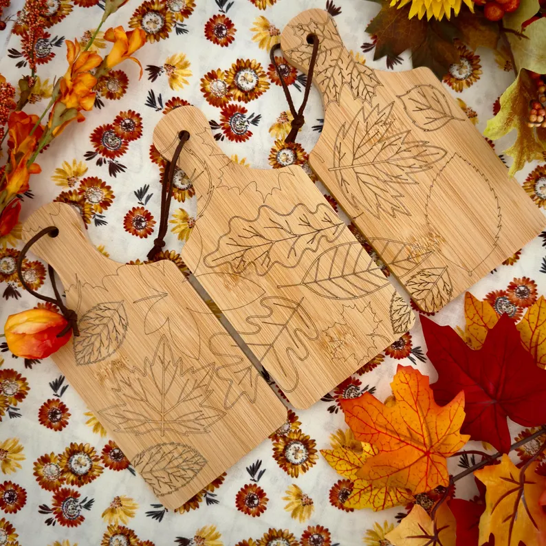 flatlay of three cheeseboards witha  fall engraved pattern etsy