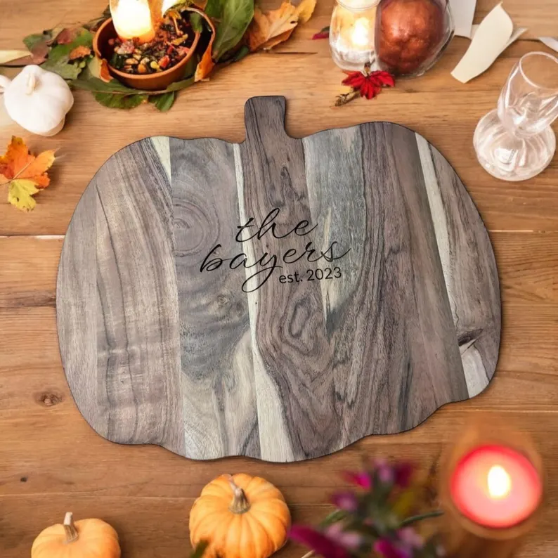 pumpking shape wooden carving baord with festive decorations and personalised name ecy