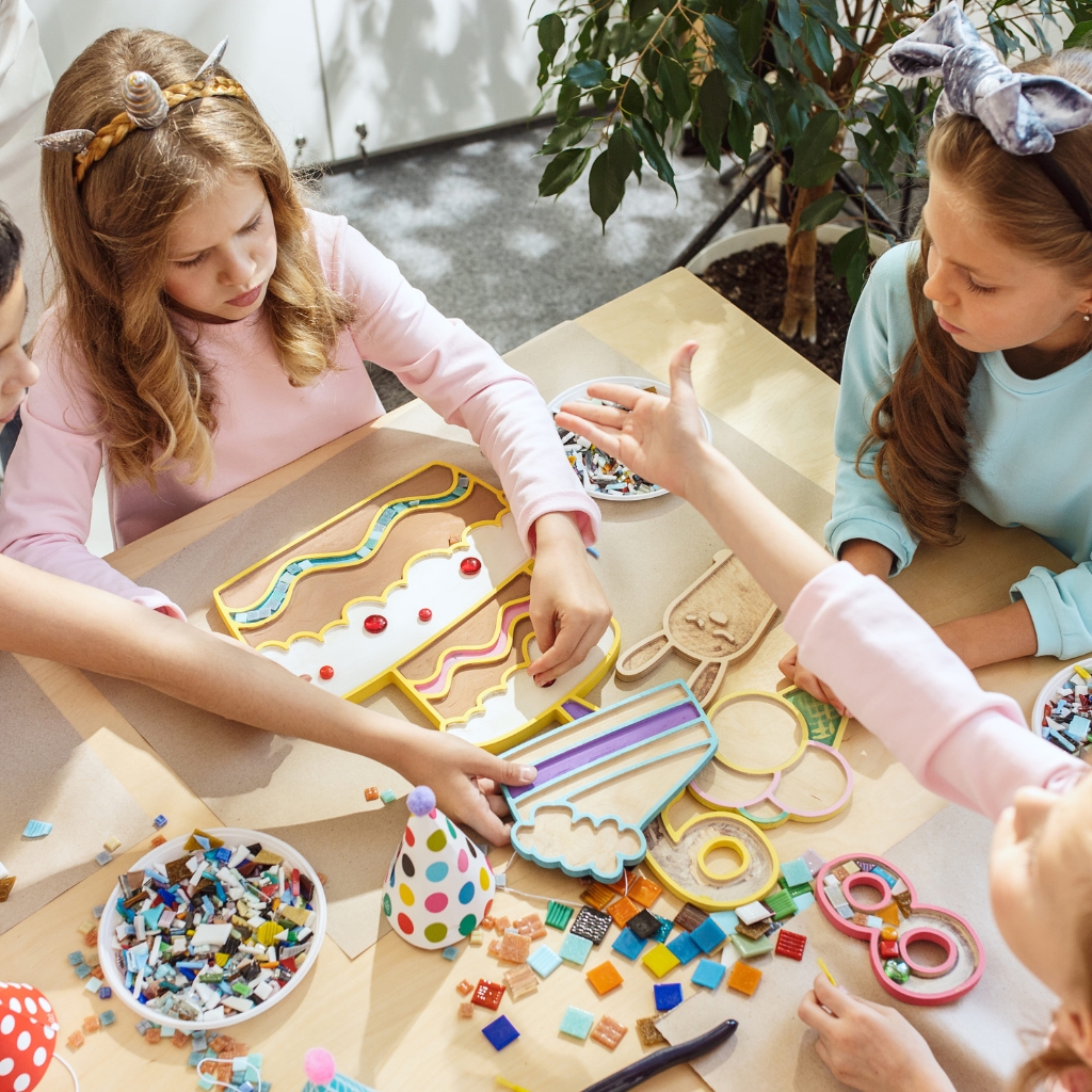girls crafting at a table overhead shot