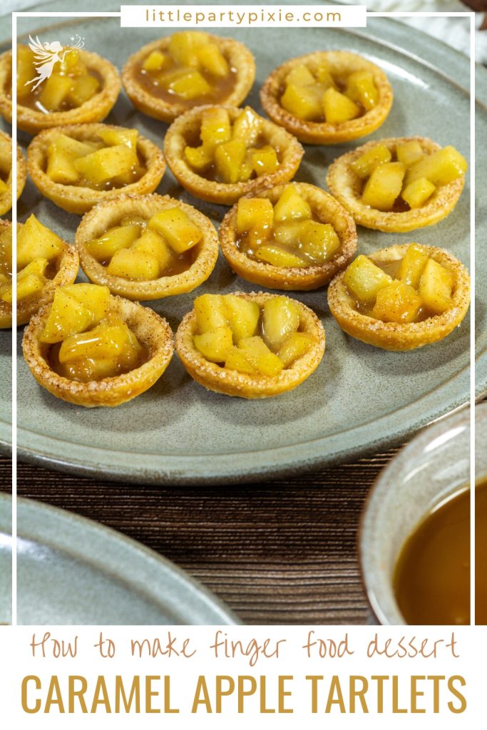 Close-up of baked mini Caramel Apple Tartlets filled with warm caramelized apple chunks on a grey plate.