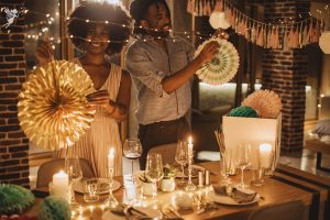man and womand setting up decorations for an ambient dinner party at home