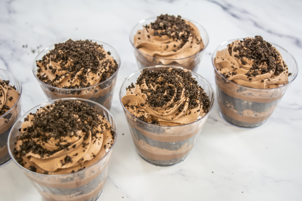 The completed and garnished Baileys Chocolate Cheesecake Trifle Cups, featuring layers of chocolate, cream, and crushed Oreos.