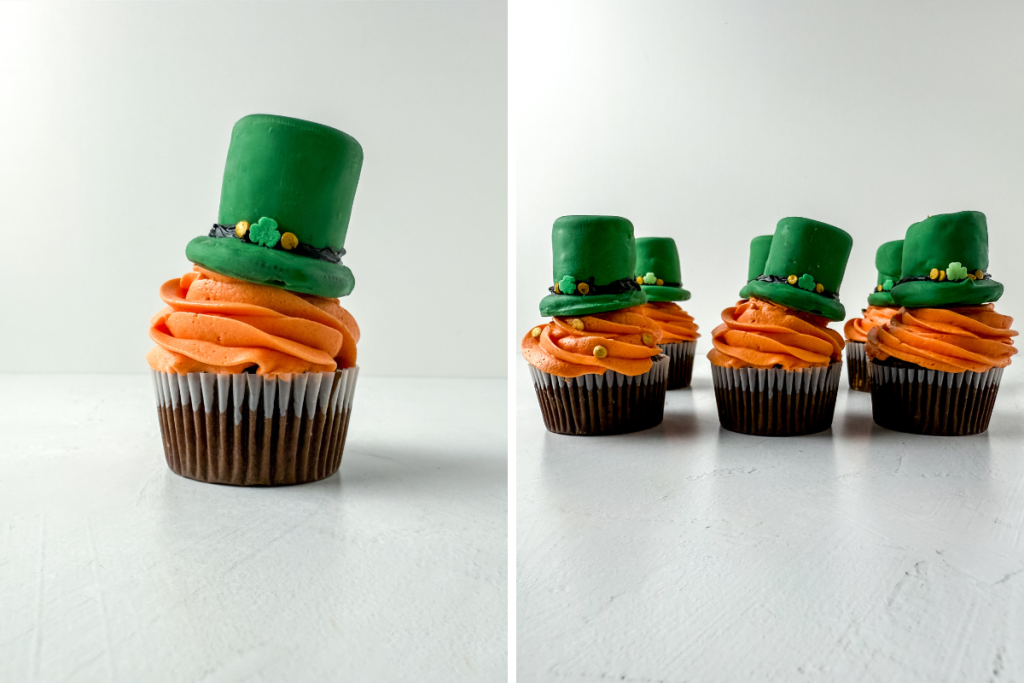 Finished Leprechaun Irish Cream Buttercream Cupcakes featuring a swirl of orange frosting and a decorated green hat topper on each cupcake.
