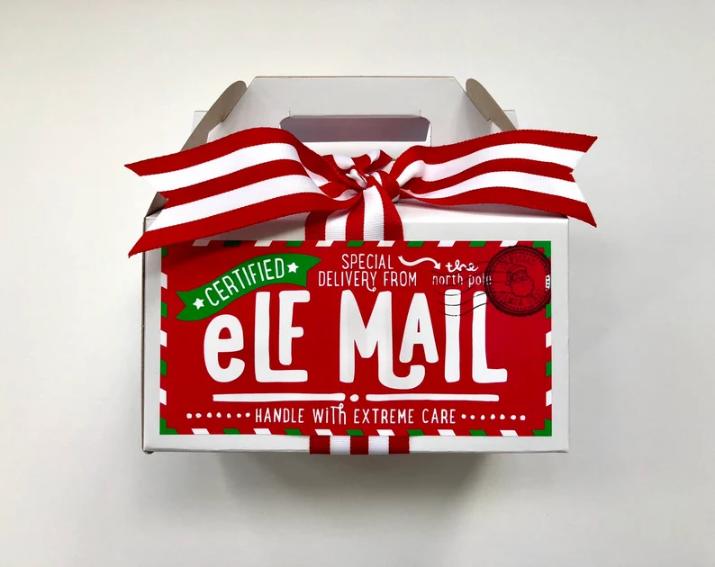 White gable box with a festive "Certified Elf Mail" sticker, a fun wrapper for Christmas Eve Boxes.