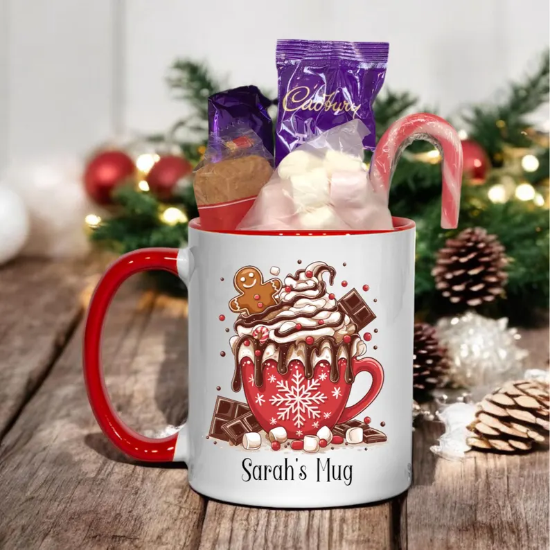 Personalized cocoa mug filled with hot chocolate mix and a candy cane, essential for a Christmas Eve Box.