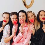 Ladies in pajamas holding love lolly pops