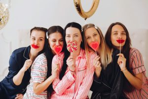 Ladies in pajamas holding love lolly pops