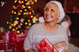 a smiling mom opening a christmas stocking