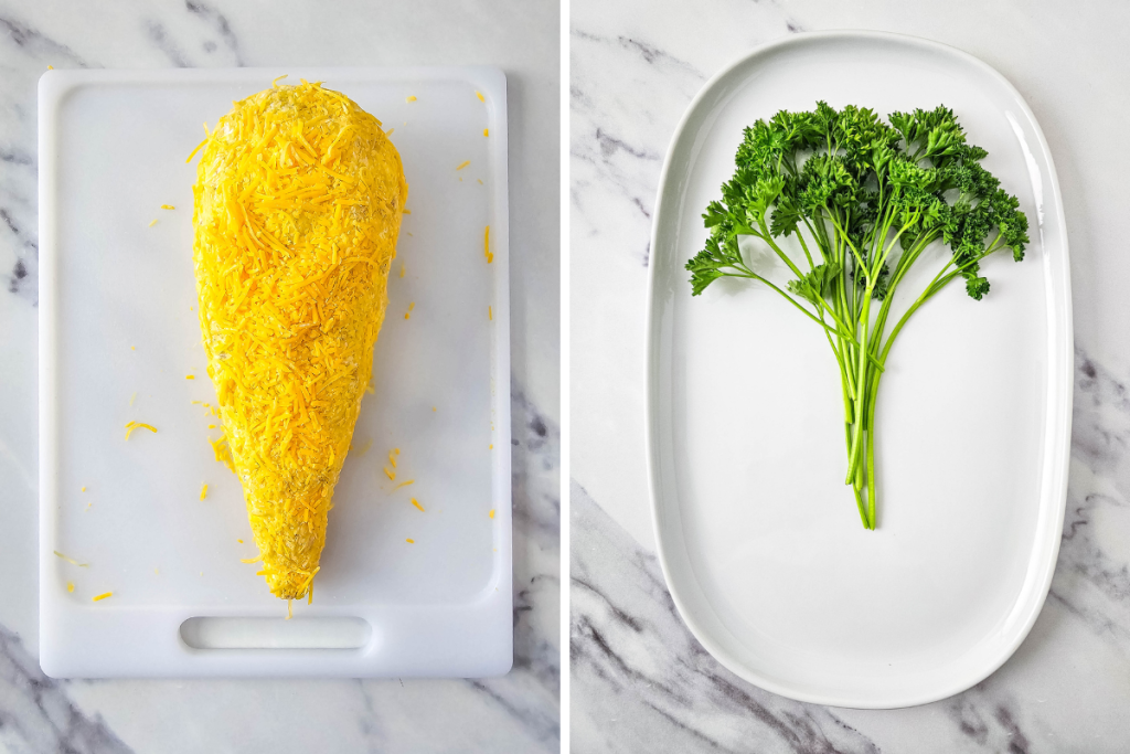 The carrot-shaped Carrot Cheese Ball coated in orange shredded cheese next to a bunch of fresh parsley for the "greens."