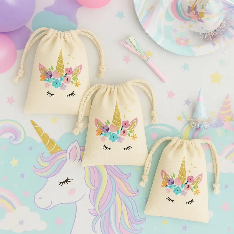 Three cream canvas drawstring bags with a floral unicorn face and gold horn graphic, perfect for holding Unicorn Party Favors. Etsy