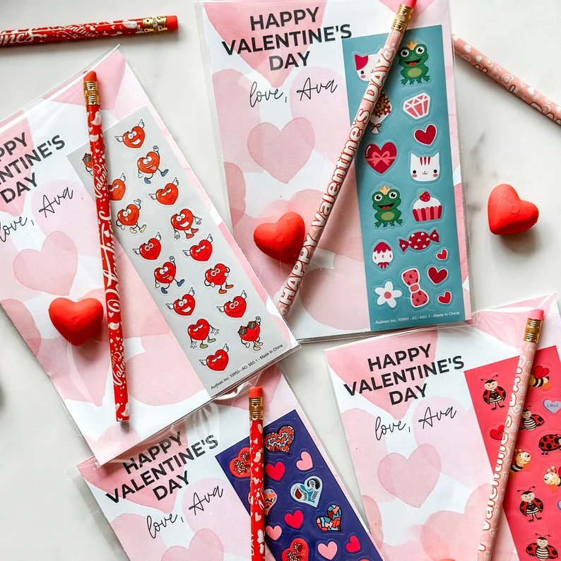 Personalized Valentine's Day Party Favors consisting of cards, pencils, and coordinating sticker sheets featuring hearts, frogs, and kittens.