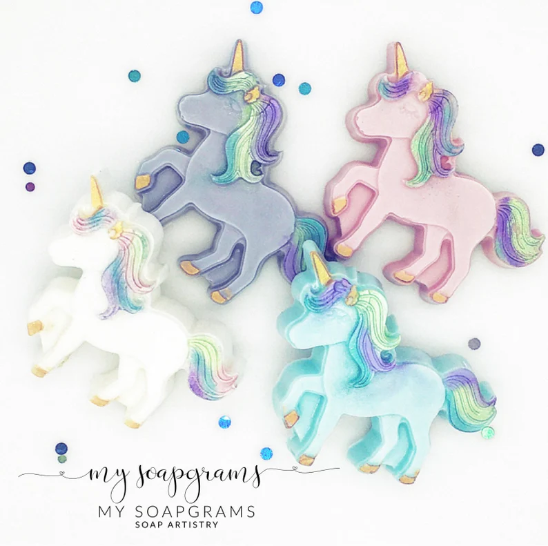 Four handmade unicorn-shaped soaps in pastel pink, blue, white, and purple, perfect for use as adorable Unicorn Party Favors. Etsy