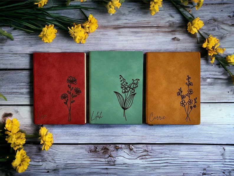 Custom leather journals embossed with delicate floral designs, making them sophisticated personalized birth month gifts for writers.