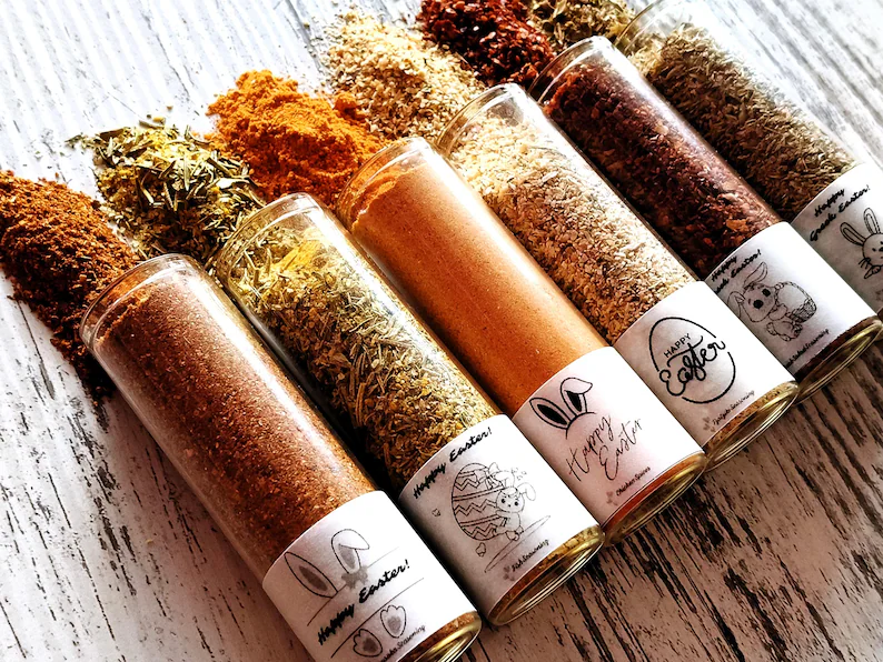 A set of gourmet glass spice tubes with festive bunny labels, a unique culinary Easter Hostess Gift.