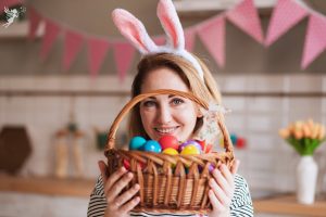 a lady in bunny ears holding an easter basket