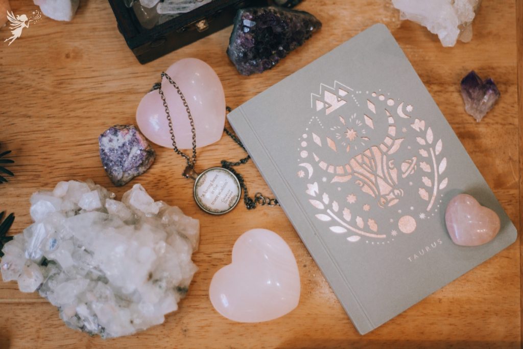 flat lay of gem stones and a diary for taurus