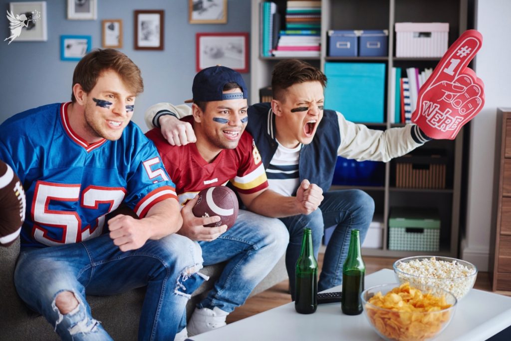 football fans shouting at tv with no 1 fan hand and party snacks