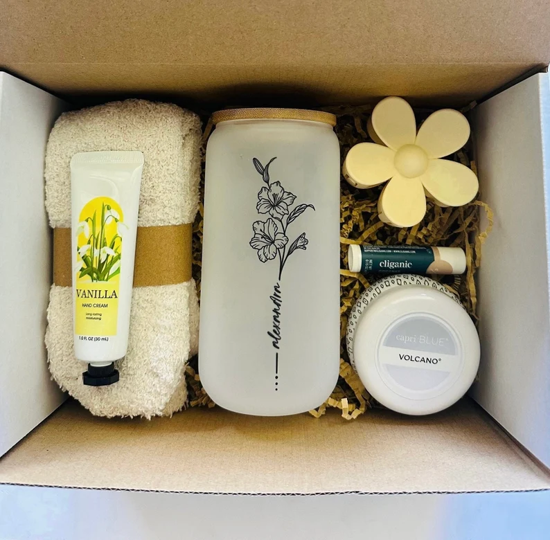 Personalized birth month gifts spa box featuring a custom floral glass tumbler, vanilla hand cream, candle, and matte flower hair claw.