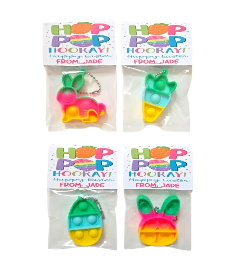 Colorful silicone fidget popper keychains in bunny, egg, and carrot shapes, featuring personalized "Hop Pop Hooray" tags for Easter Party Favors Kids.